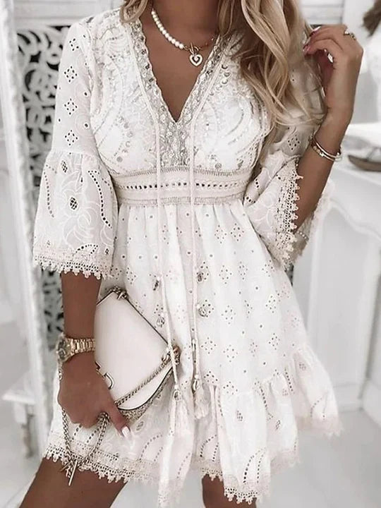Boho chic women's embroidered mini dress with flare sleeves, relaxed fit. Ideal for spring, vacation, or casual wear.