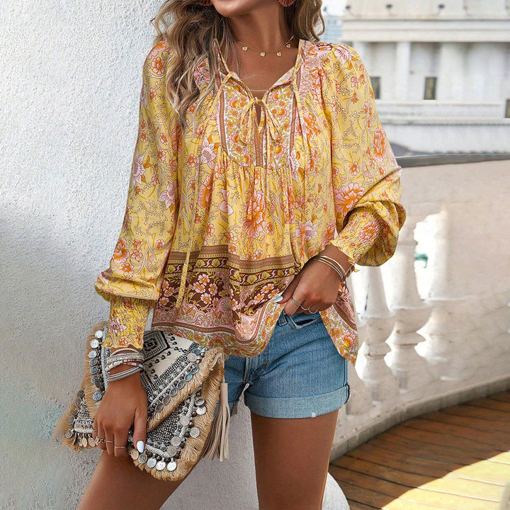 Loose fit women's floral boho top with stylish puff sleeves & V-neck. Comfortable summer fashion.