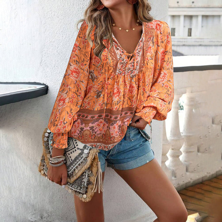 Women's boho floral blouse featuring puff sleeves & V-neck. Loose fit, perfect for casual summer style.