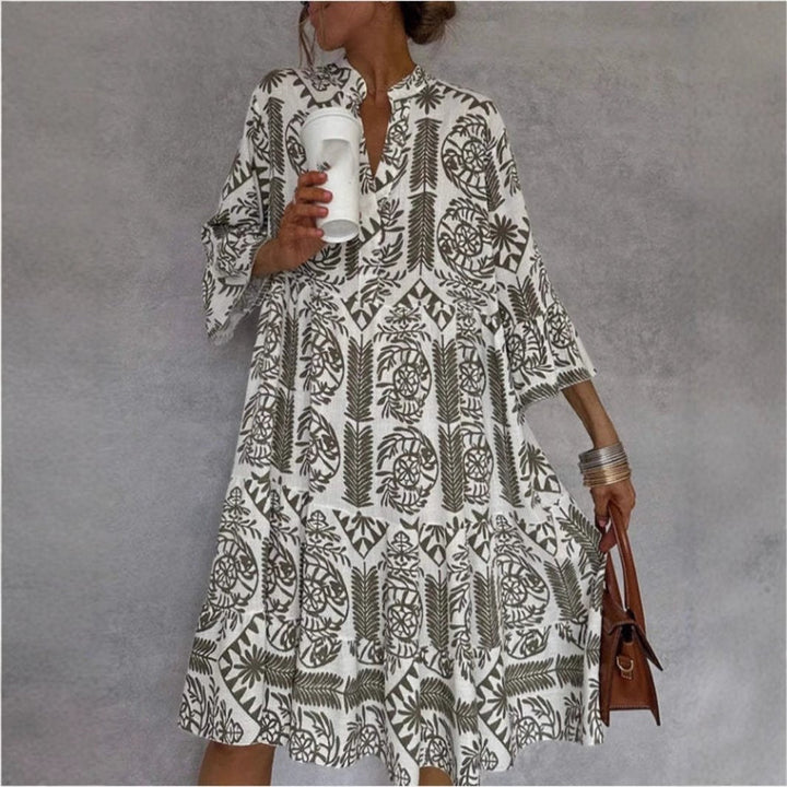 Light blue boho floral sundress for women, featuring a tiered skirt & elbow sleeves for resort wear.