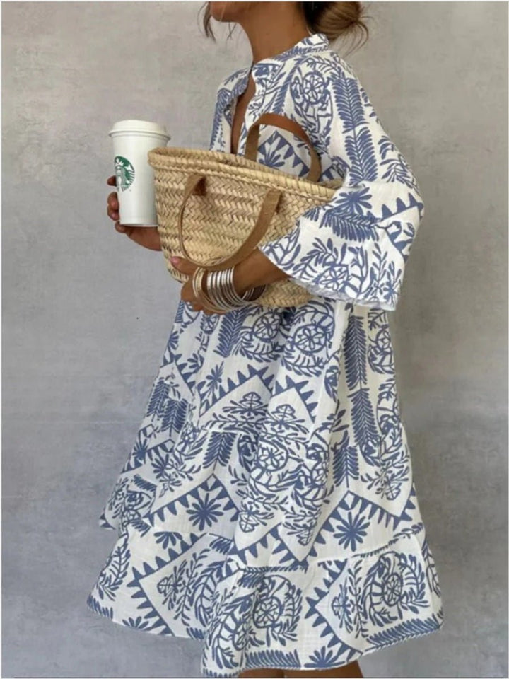 Women's floral tunic sundress with tiered skirt, boho elbow sleeve style for summer casual fashion.