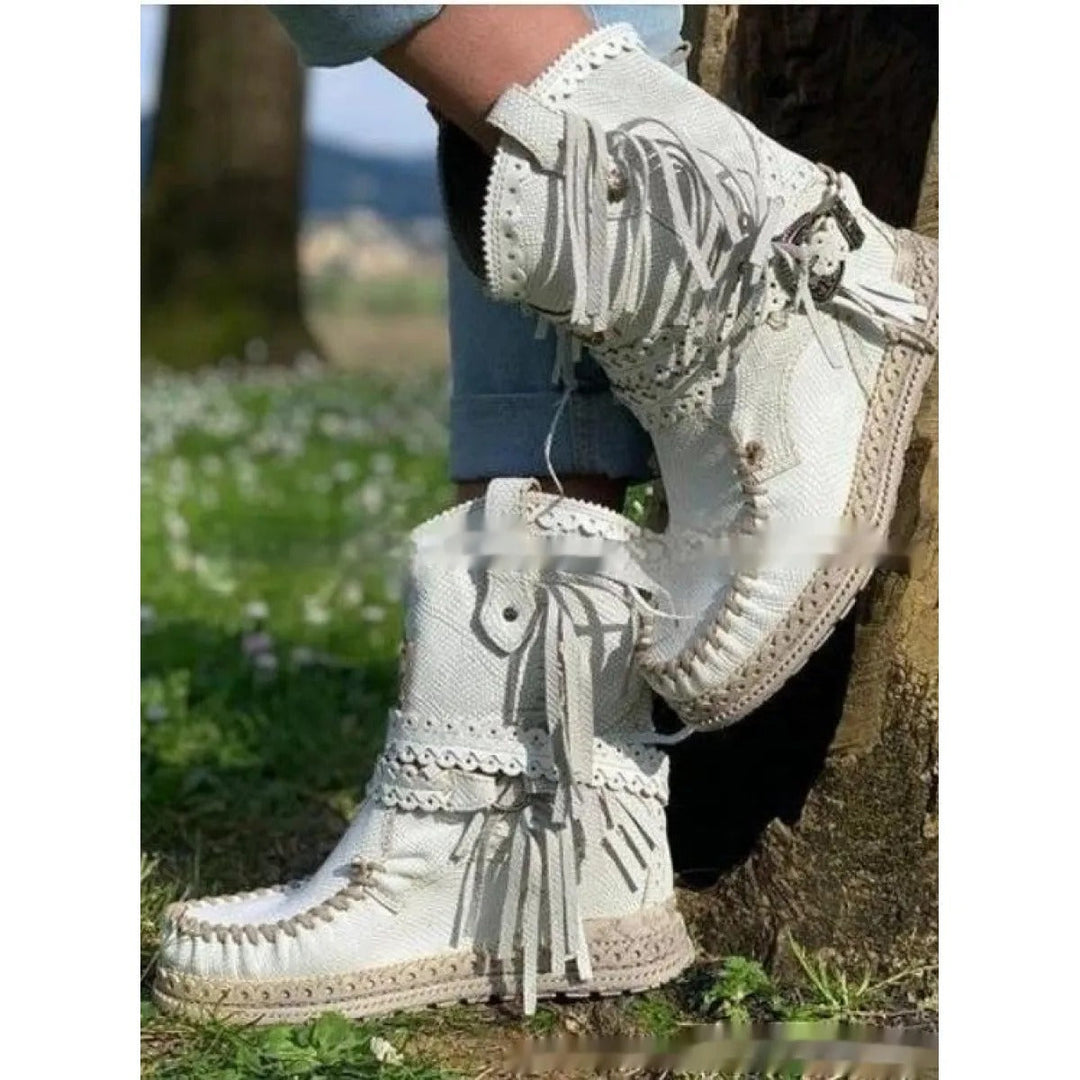 Boho western ankle boots for women, detailed with fun fringe. Round toe, flat heel for comfortable, travel-friendly wear.