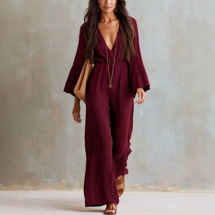 Elegant women's boho V-neck wide leg jumpsuit with flowy flare sleeves. Chic one-piece for summer fashion & vacations.