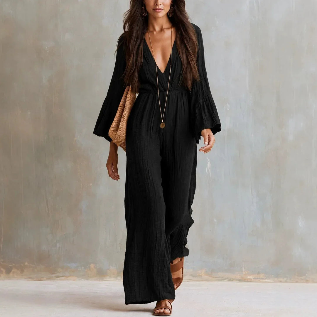 Chic women's boho wide leg jumpsuit featuring a deep V-neck and stylish flare sleeves. A comfortable one-piece outfit.