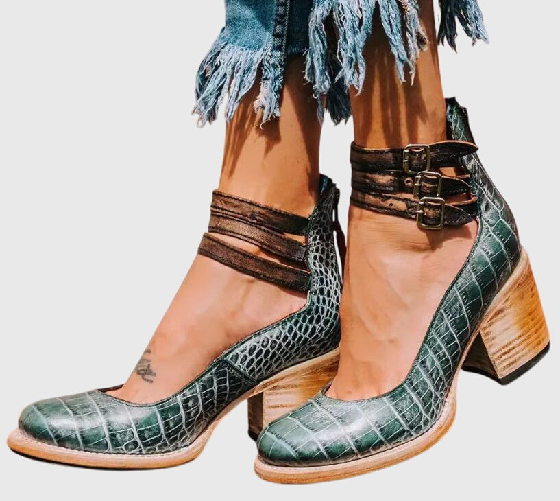 Women's ankle boots with bold buckle straps, cutout details, and a durable block heel for fashion & comfort.