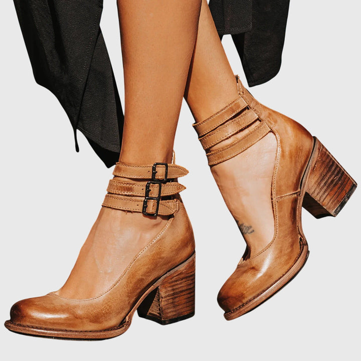 Casual women's western-inspired ankle boots with bold buckle straps, cutouts & comfortable block heel.