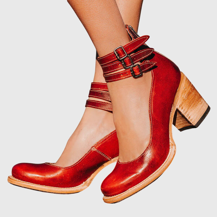 Statement women's cutout ankle boots with bold buckle straps & block heel. Fashion-forward stylish footwear.