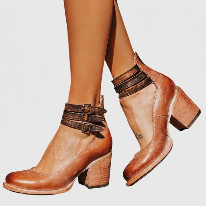 Versatile women's fashion ankle boots, featuring bold buckle straps, cutout details, and a comfortable block heel.