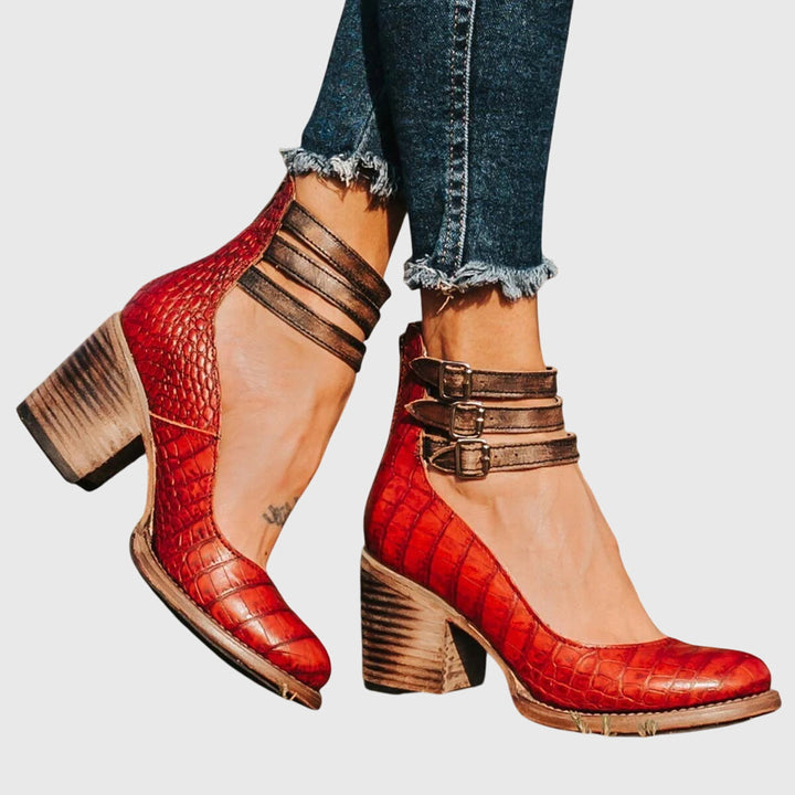 Fashion-forward women's cutout ankle boots. Bold buckle straps & block heel make a stylish statement.