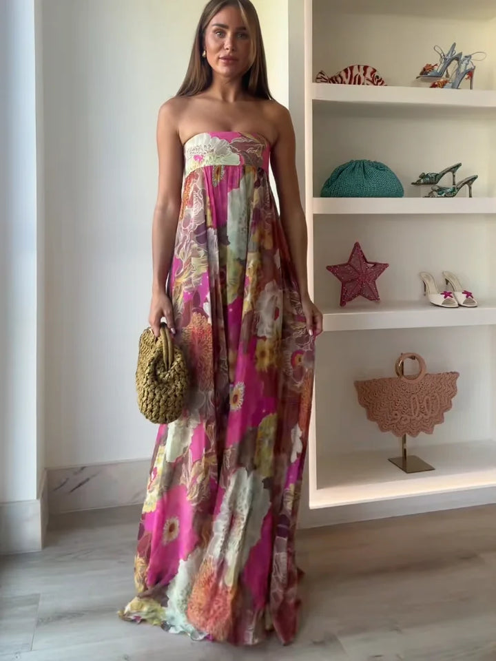 Women's bold floral strapless maxi dress with empire waist, perfect for wedding guests or summer parties.