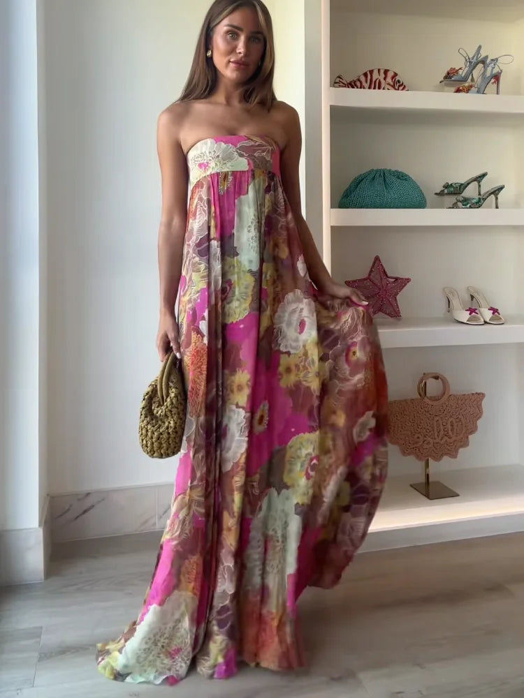 Elegant flowy strapless maxi dress for women featuring a vibrant, bold floral print and empire waist.