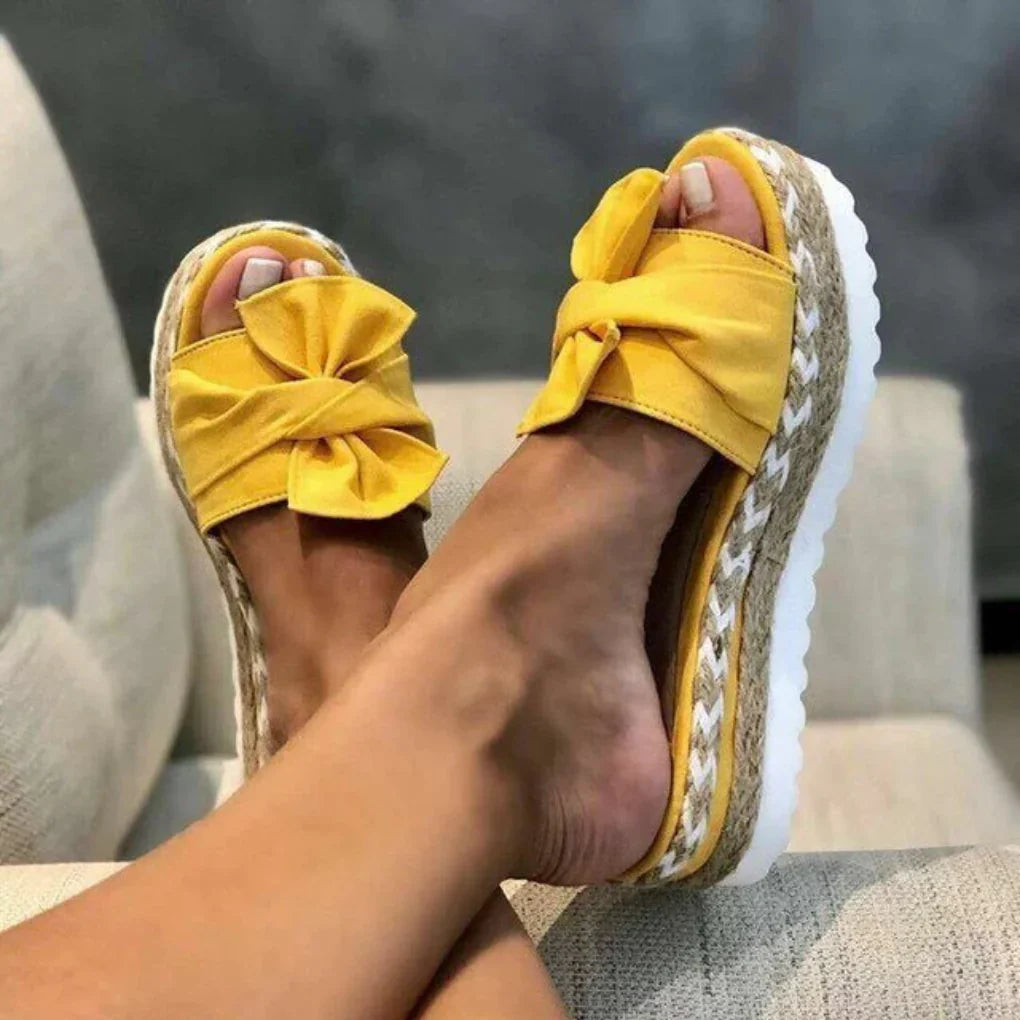 Chic women's platform slides with a decorative bow detail, designed for ultimate comfort and style
