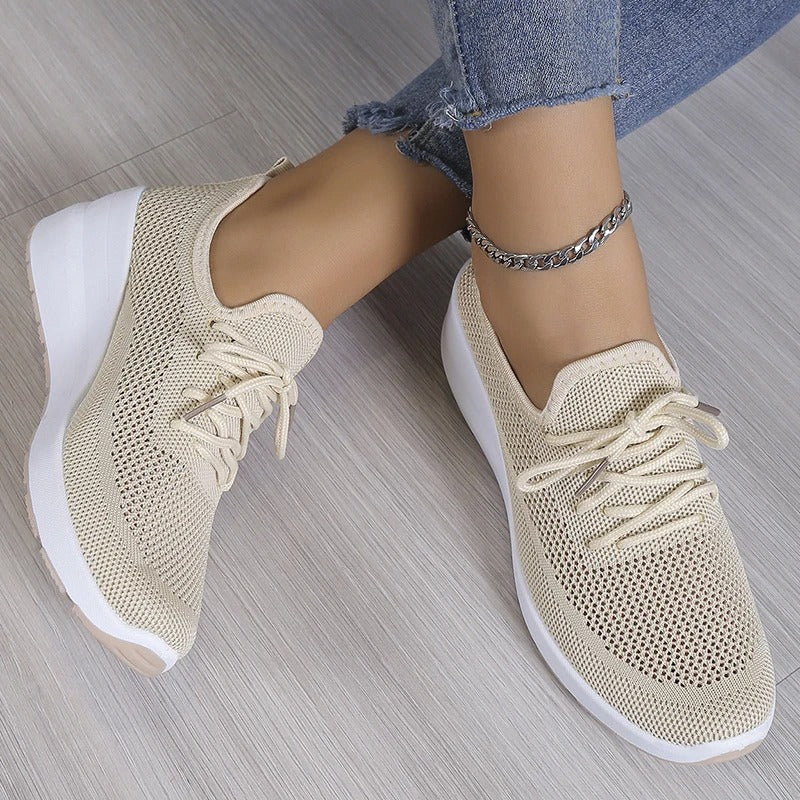 Stylish women's wedge platform sneakers. Breathable design offers elevated comfort & modern casual style.