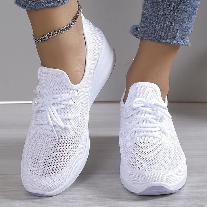 Fashionable women's casual platform wedge sneakers. Breathable design for comfortable, elevated style.