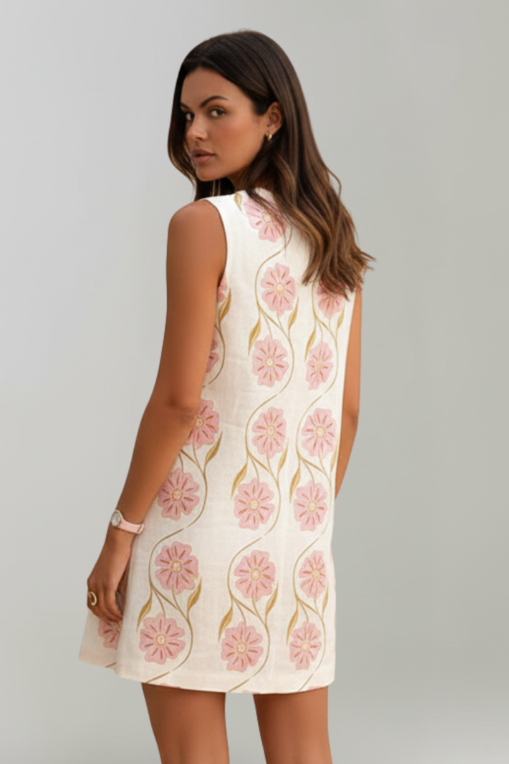 Sleeveless pink floral mini dress for women, A-line, round neck. A casual and breezy summer dress, great for vacations.