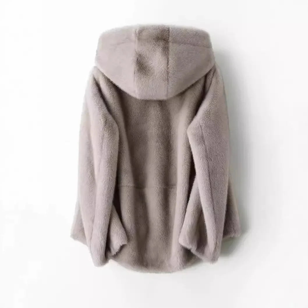 Detailed view of the soft faux fur and hood on a women's winter jacket, warm outerwear
