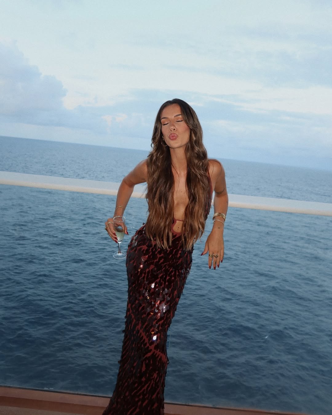Fitted sparkling burgundy sequin evening wear, a chic plunge neckline maxi dress for prom or special events.