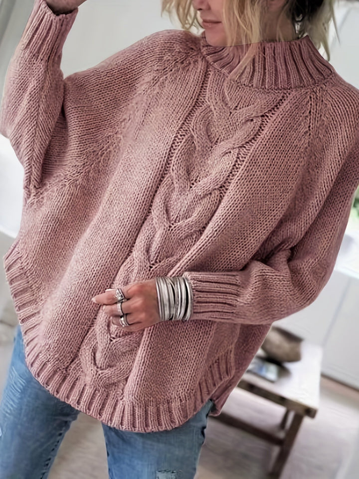 Women's cable knit high-neck sweater with elegant flared hem. Perfect for cozy fall fashion.