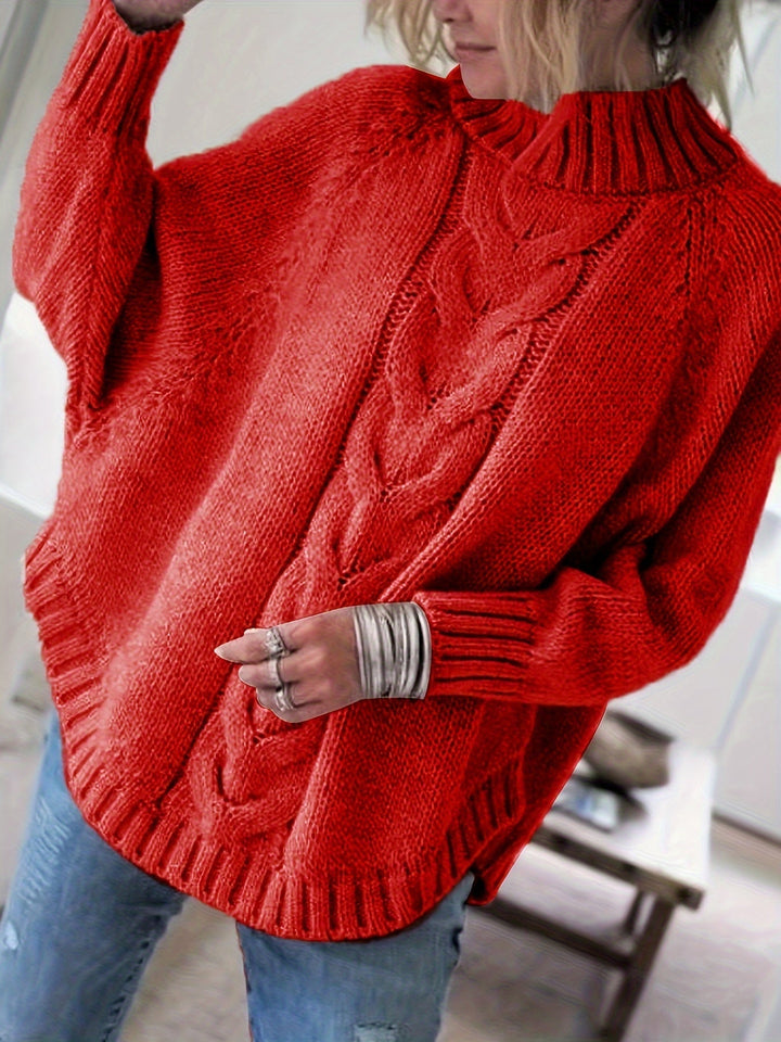 Oversized cable knit women's sweater with a stylish high neck and comfortable flared hem. Long sleeve.