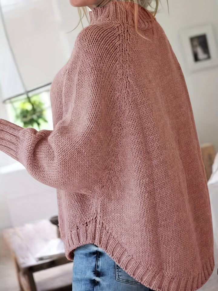 Relaxed fit women's cable knit sweater, high neck, flared hem. Embrace cozy casual wear this fall.