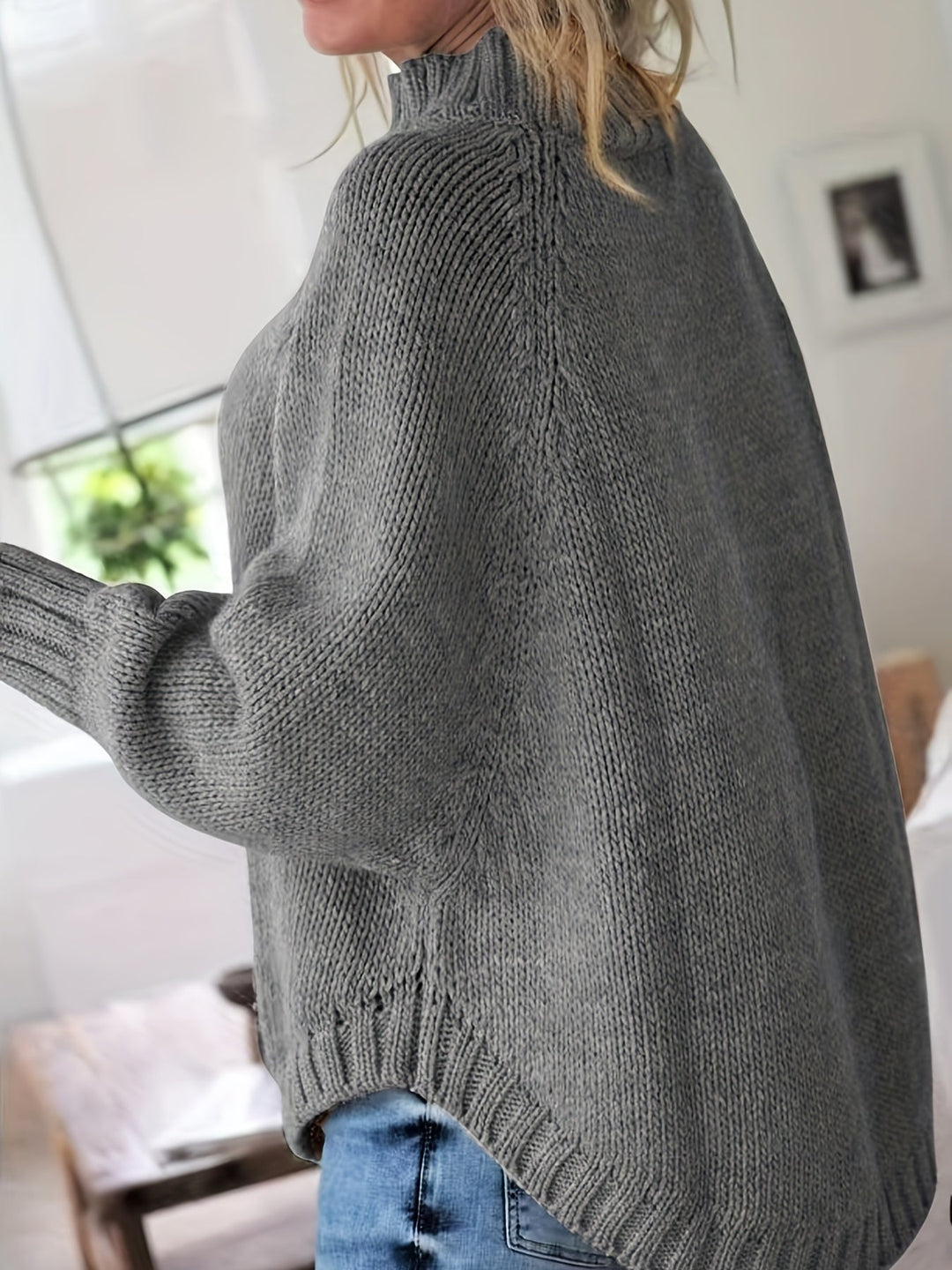 Stylish women's high-neck cable knit sweater. Long sleeve, flared hem, perfect for cool weather comfort.