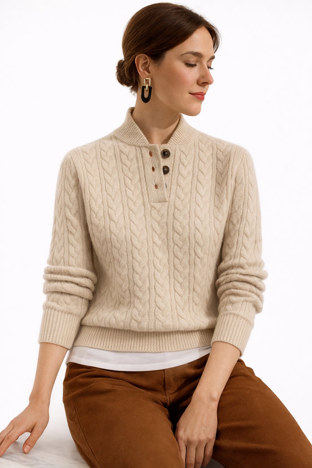 Chic women's cable knit pullover sweater featuring elegant button-neck. Essential knitwear for fall/winter style.