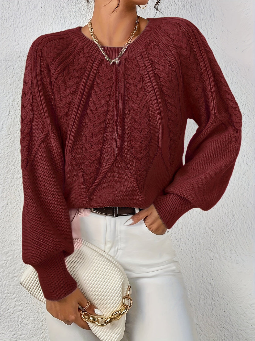 Model wearing a cozy women's cable knit sweater with relaxed fit and lantern sleeves.