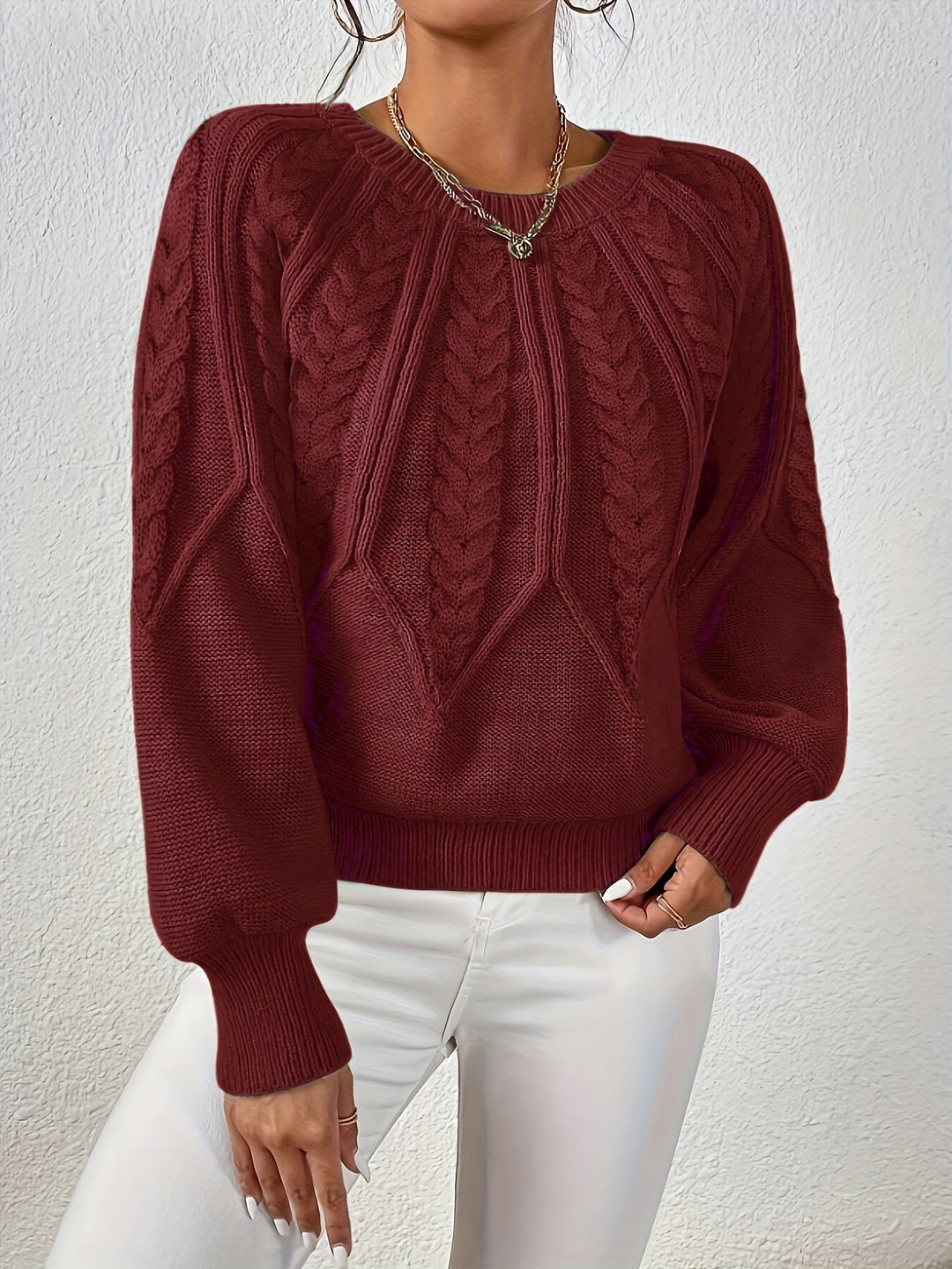 Women's relaxed fit cable knit sweater, a chic top for fall and winter.