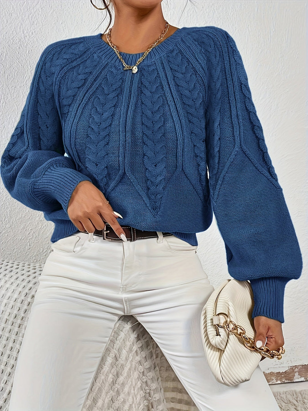Comfortable women's cable knit sweater, relaxed fit, lantern sleeves, cozy style.