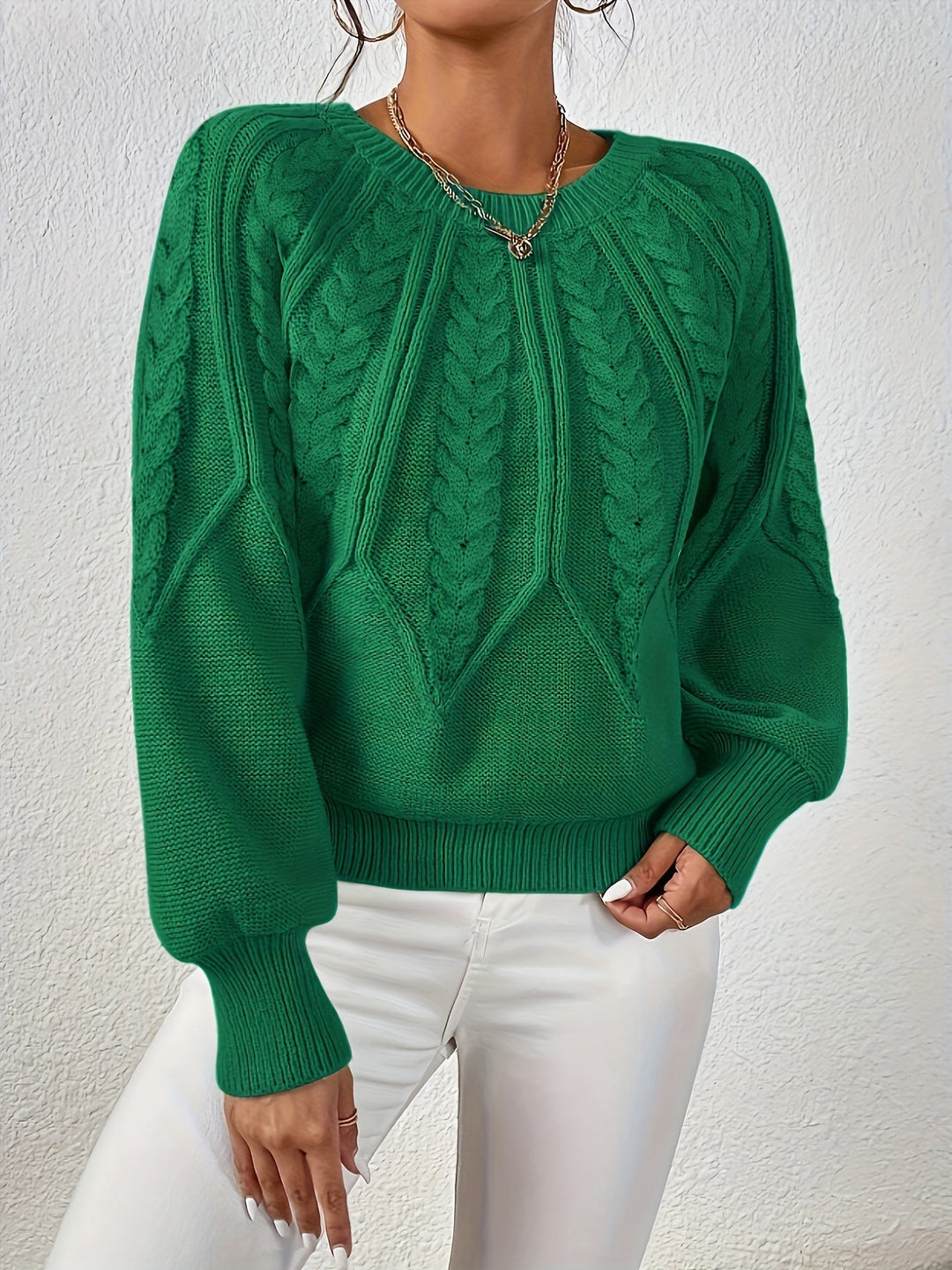 Elegant cable knit women's pullover, relaxed fit, unique lantern sleeve detail.
