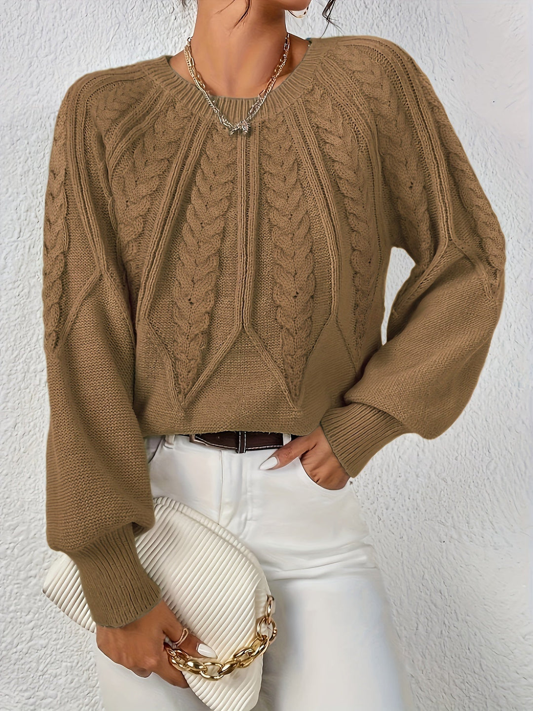 Women's cable knit pullover, relaxed fit, lantern sleeves, offering cozy comfort.