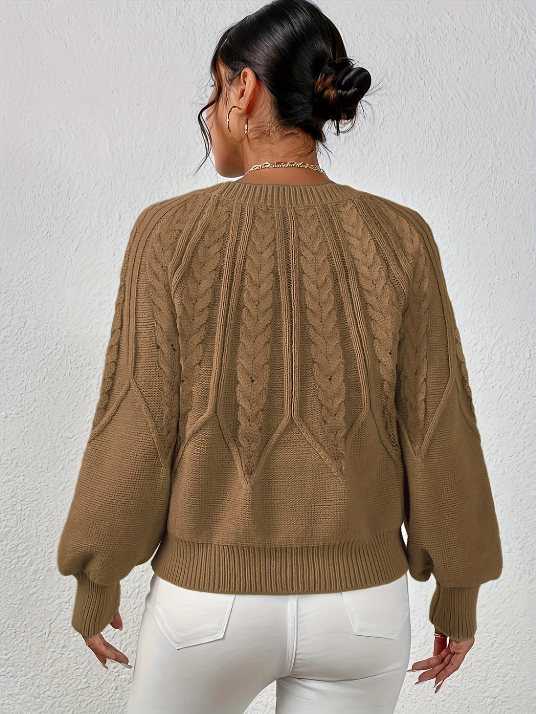 Stylish women's cable knit sweater, relaxed fit, with eye-catching lantern sleeves.