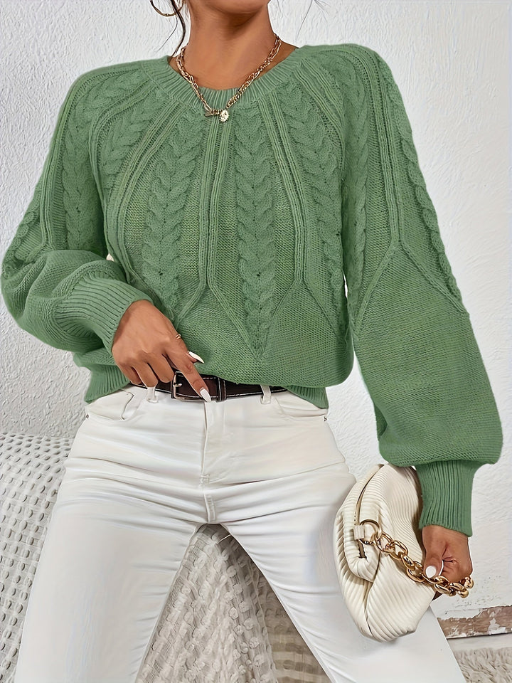 Elegant women's cable knit sweater featuring a relaxed fit and unique lantern sleeves.