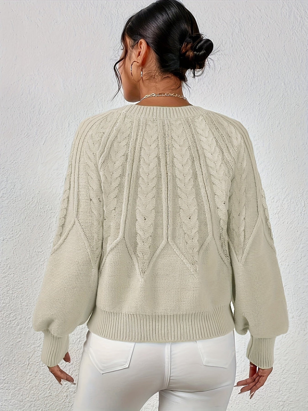 Fall fashion women's cable knit sweater with relaxed fit, cozy lantern sleeves.