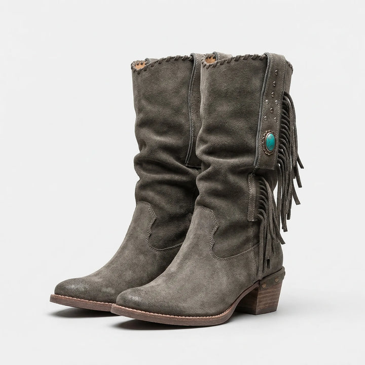 Women's Caroline mid-calf slip-on western boots with fringe detail, pointed toe, and sturdy block heel.