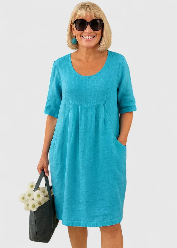 Comfortable women's casual midi dress. A-line silhouette, scoop neck, and convenient pockets for summer.