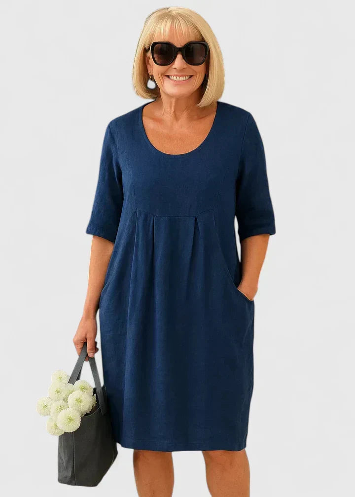 Versatile women's A-line midi summer dress with scoop neck and side pockets. Perfect for casual wear.