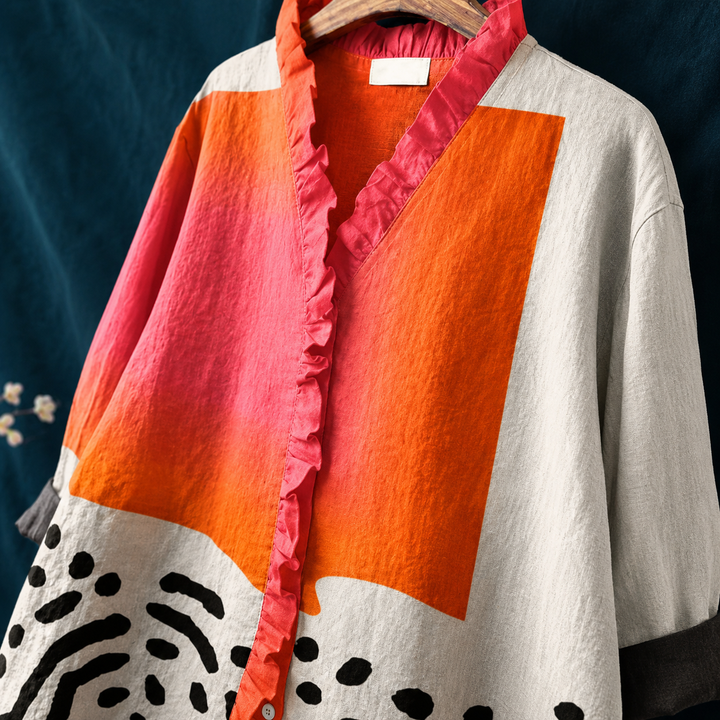Relaxed fit women's summer blouse, abstract block pattern, ruffled collar, button-up, and long sleeves.