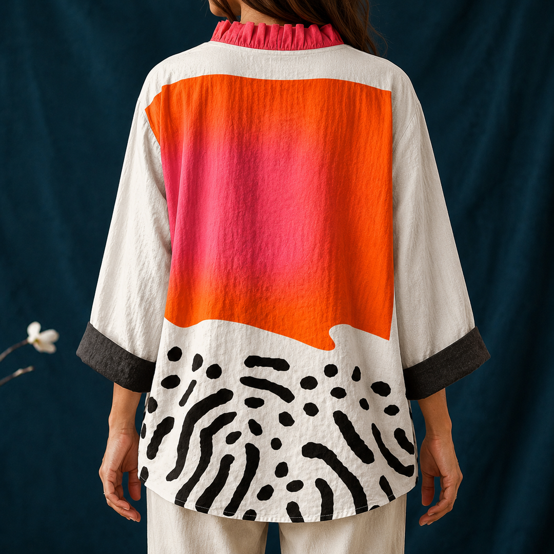 Trendy women's casual top featuring a vibrant abstract block print, elegant ruffled collar & long sleeves.