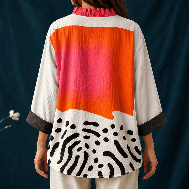 Trendy women's casual top featuring a vibrant abstract block print, elegant ruffled collar & long sleeves.
