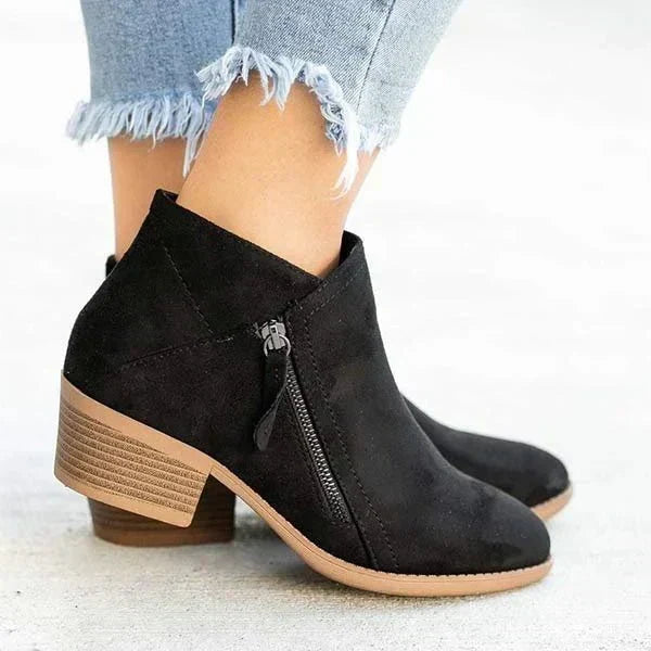 Comfortable women's block heel ankle boots featuring a practical side zip and sleek design for daily wear.