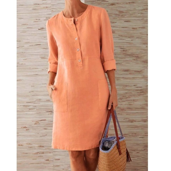 Stylish women's midi shift dress featuring practical pockets & full button-front detail. Effortless spring/summer style.