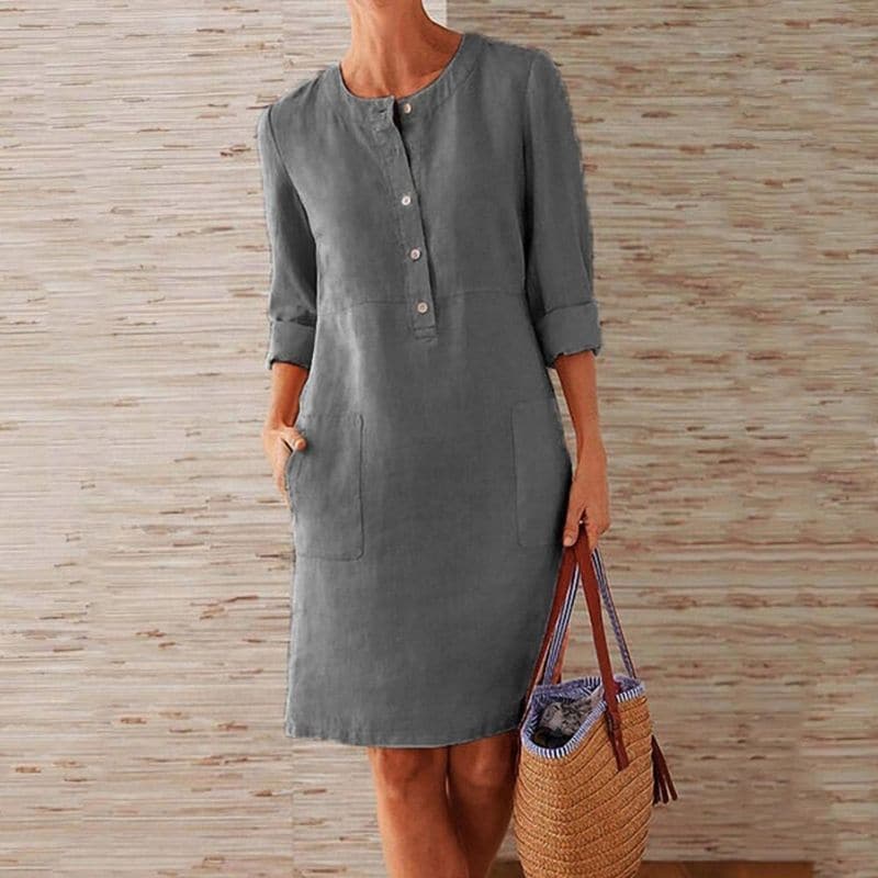 Relaxed fit women's button-front shift dress. Midi length with pockets, a comfortable and versatile casual dress.