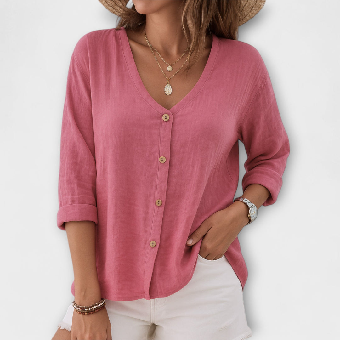 White women's casual button-up blouse, long sleeve, V-neck. Effortless relaxed fit top, ideal for versatile everyday fashion.