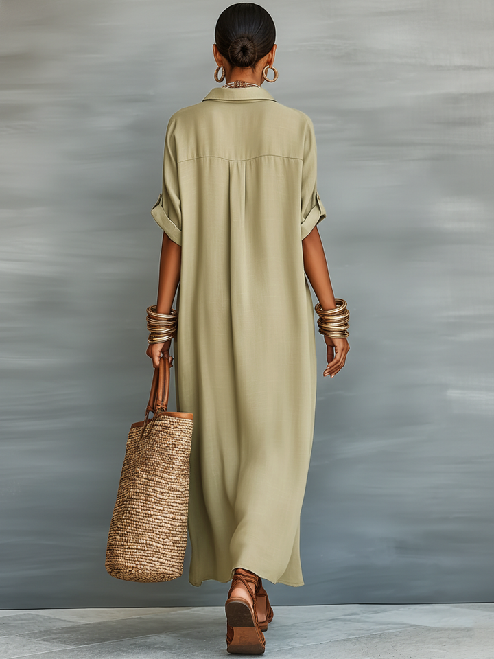 Flowy women's maxi shirt dress with collared button front and elbow sleeves. Comfortable relaxed fit.