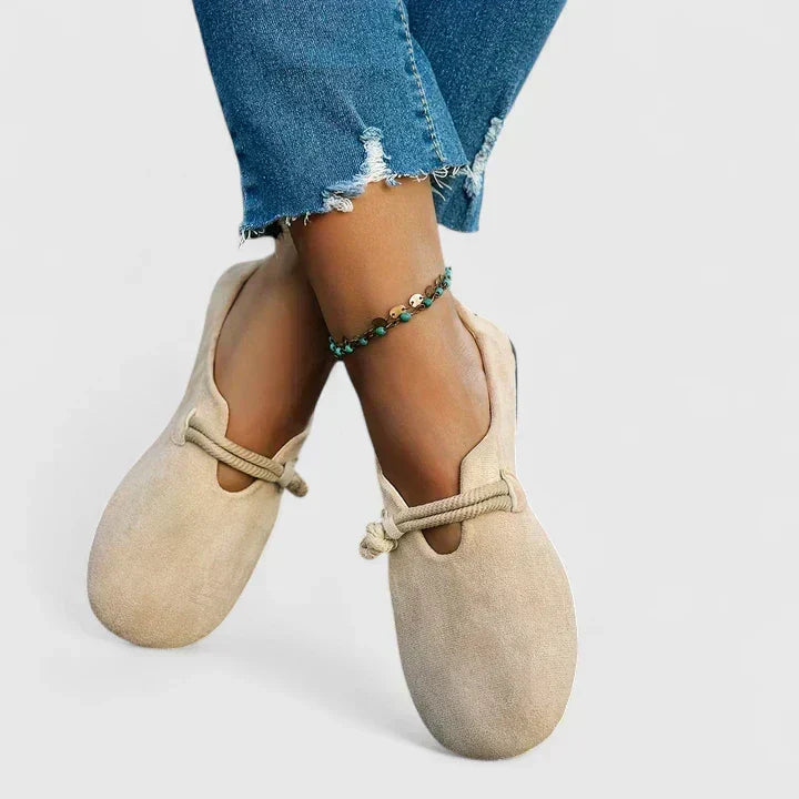 Stylish women's slip-on flat loafers with distinctive rope ties and a comfortable rounded toe design.