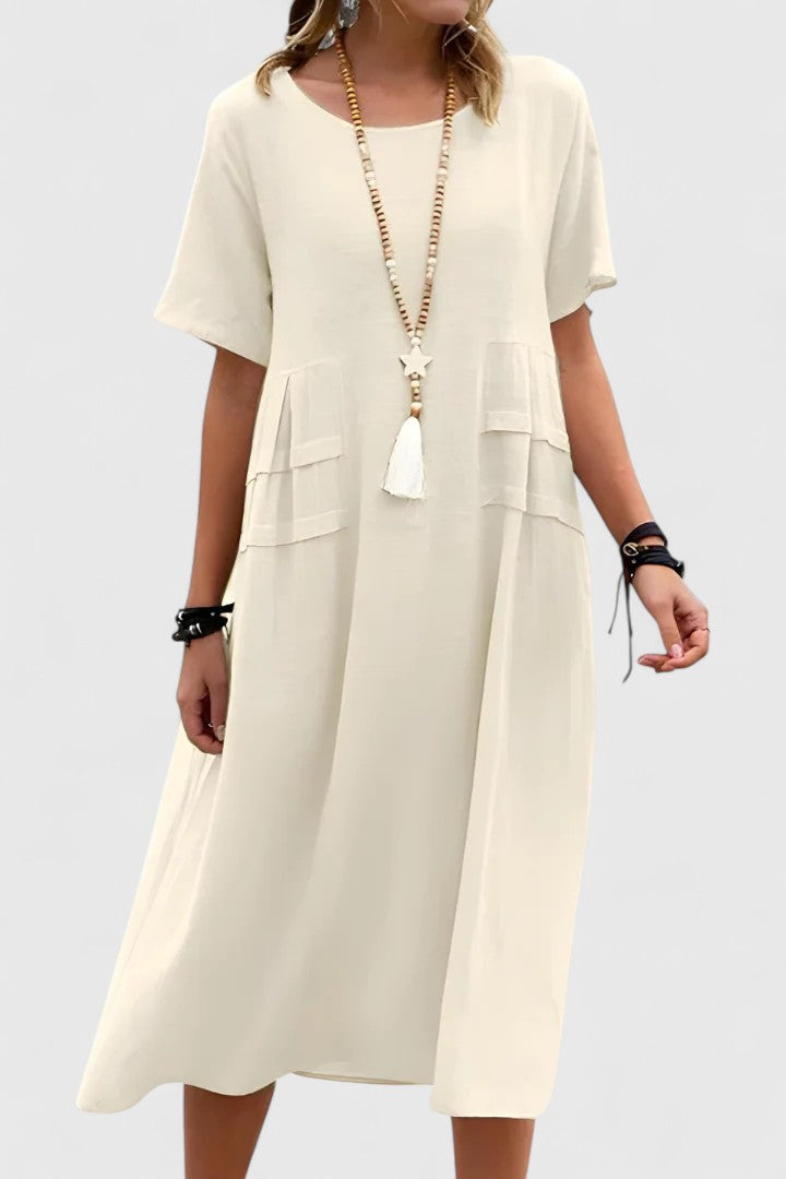 Comfortable women's flowy short sleeve midi dress with pockets, ideal for casual summer vacations.