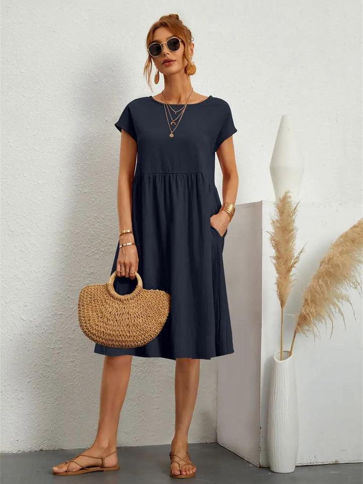 Stylish short sleeve summer midi dress for women, featuring a casual design and useful pockets.