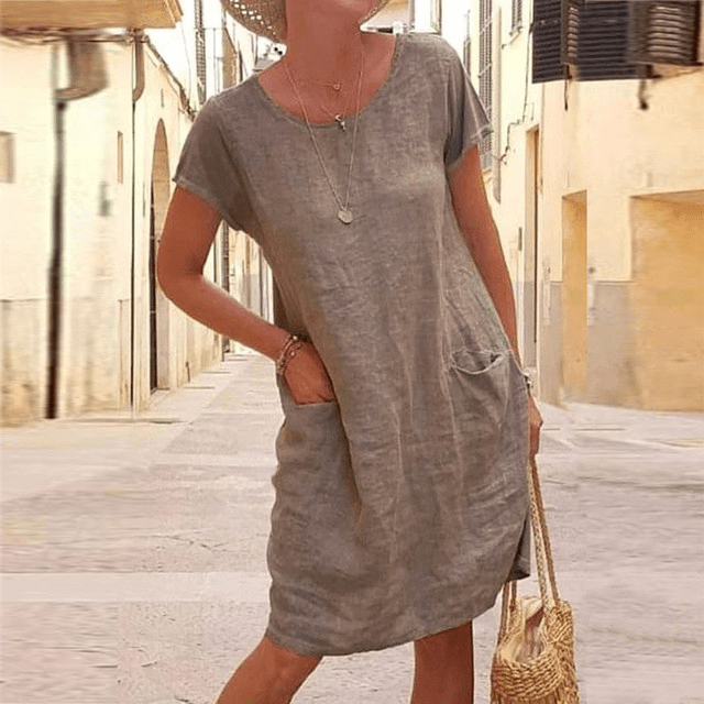 Relaxed fit women's casual mini dress with convenient pockets, short sleeves & round neck. Ideal for daily wear.