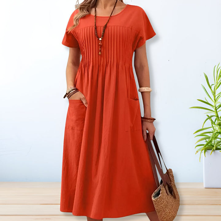 Versatile pleated midi dress for women, featuring a relaxed fit & practical pockets, ideal for casual everyday comfort.